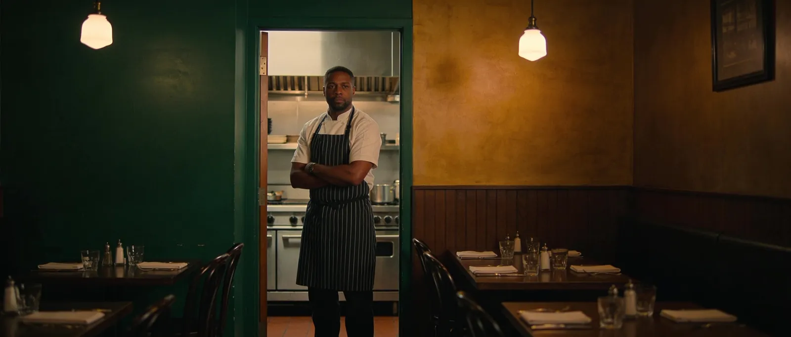A restaurant owner standing in their dining room